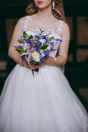 Bride holding big wedding bouquet on wedding ceremonyの写真素材