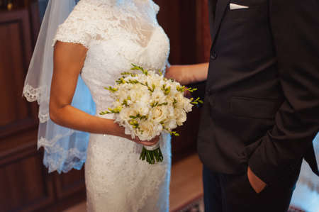 Bride holding big wedding bouquet on wedding ceremonyの写真素材