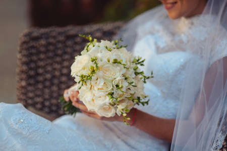 Bride holding big wedding bouquet on wedding ceremonyの写真素材