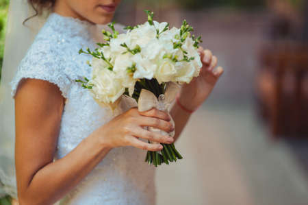 Bride holding big wedding bouquet on wedding ceremonyの写真素材