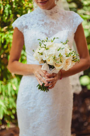 Bride holding big wedding bouquet on wedding ceremonyの写真素材