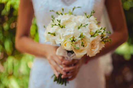 Bride holding big wedding bouquet on wedding ceremonyの写真素材