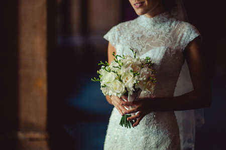 Bride holding big wedding bouquet on wedding ceremonyの写真素材