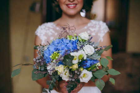 Bride holding big wedding bouquet on wedding ceremonyの写真素材