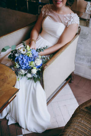 Bride holding big wedding bouquet on wedding ceremonyの写真素材