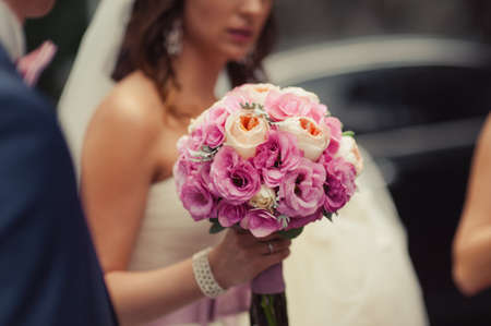 Bride holding big wedding bouquet on wedding ceremonyの写真素材