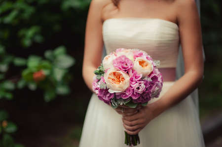 Bride holding big wedding bouquet on wedding ceremonyの写真素材