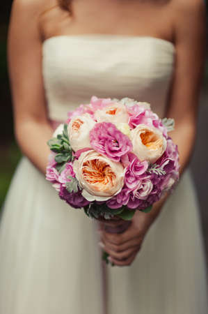 Bride holding big wedding bouquet on wedding ceremonyの写真素材