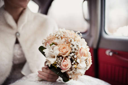 Bride holding big wedding bouquet on wedding ceremonyの写真素材
