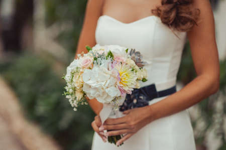 Bride holding big wedding bouquet on wedding ceremonyの写真素材