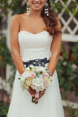 Bride holding big wedding bouquet on wedding ceremonyの写真素材