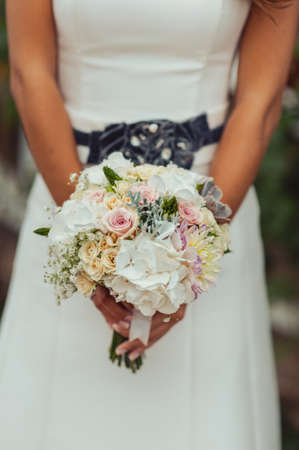 Bride holding big wedding bouquet on wedding ceremonyの写真素材