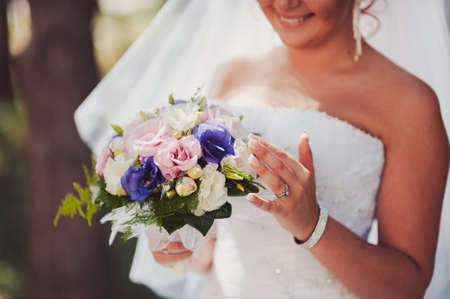 Bride holding big wedding bouquet on wedding ceremonyの写真素材