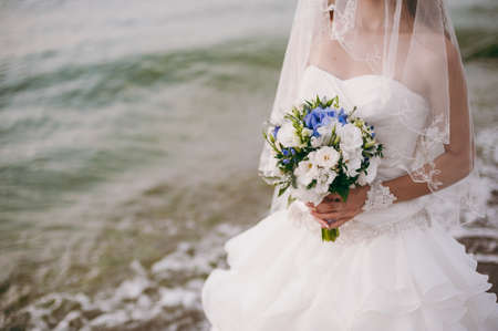Bride holding big wedding bouquet on wedding ceremonyの写真素材