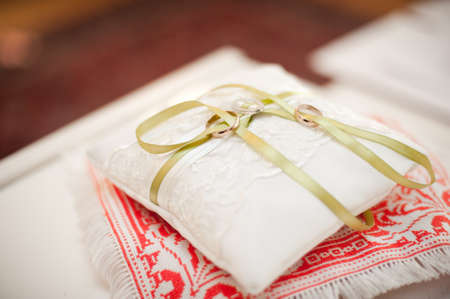 Two wedding rings on the pillowの写真素材