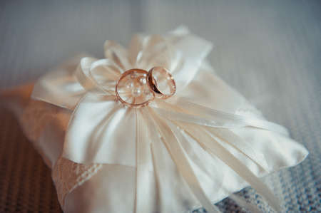 Two wedding rings on the pillowの写真素材