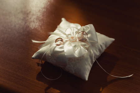 Two wedding rings on the pillowの写真素材