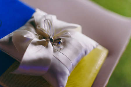 Two wedding rings on the pillowの写真素材