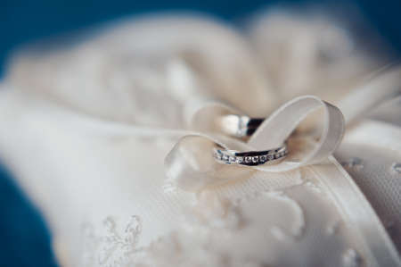 Two wedding rings on the pillowの写真素材