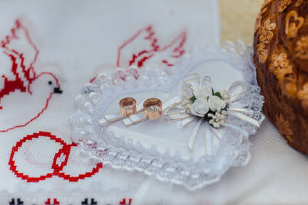 Two wedding rings on the pillowの写真素材