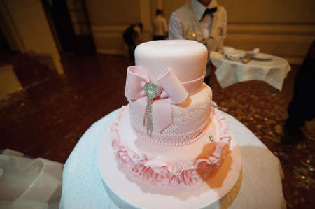 Beautiful white and colored wedding cake. A bride and a groom is cutting their wedding cakeの写真素材