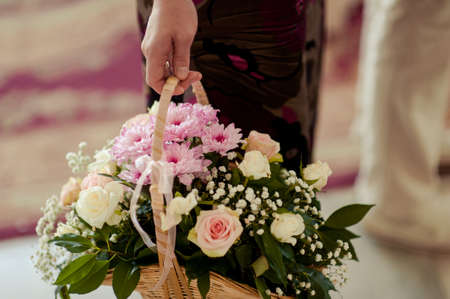 Valentines day or proposal. Young happy handsome man holding big bunch of red roses in his hand on grey background, studio shotの写真素材