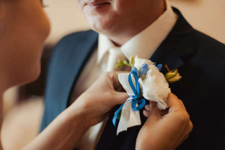wedding boutonniere with natural flowers on a jacketの写真素材