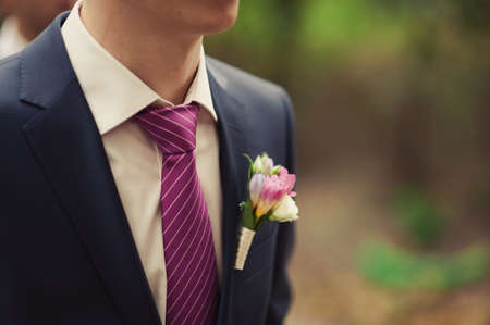 wedding boutonniere with natural flowers on a jacketの写真素材