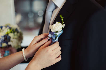 wedding boutonniere with natural flowers on a jacketの写真素材