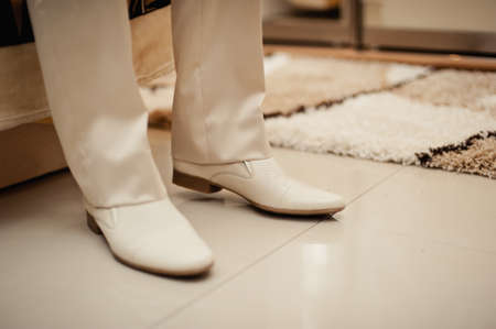 The man wears shoes. Tie the laces on the shoes. Men's style. Professions. To prepare for work, to the meeting.の写真素材