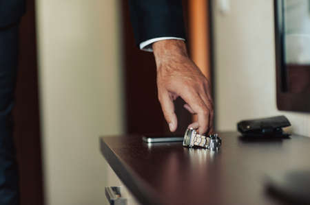 The man fastens the watch on his handの写真素材
