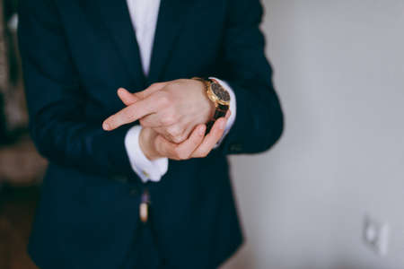 The man fastens the watch on his handの写真素材