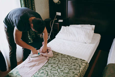 The man ironing the shirt in hotelの写真素材
