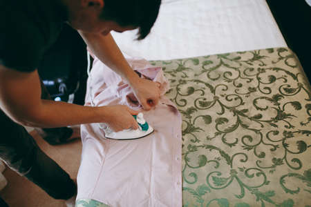 The man ironing the shirt in hotelの写真素材