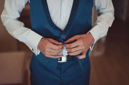 A man dresses a jacket of black, blue, gray and color