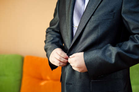 A man dresses a jacket of black, blue, gray and colorの写真素材