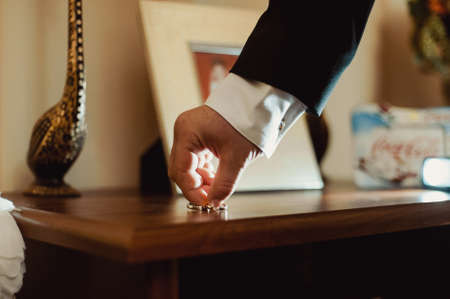 The groom takes a wedding ringsの写真素材
