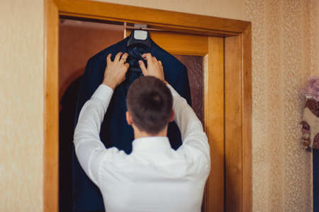 A man dresses a jacket of black, blue, gray and colorの写真素材