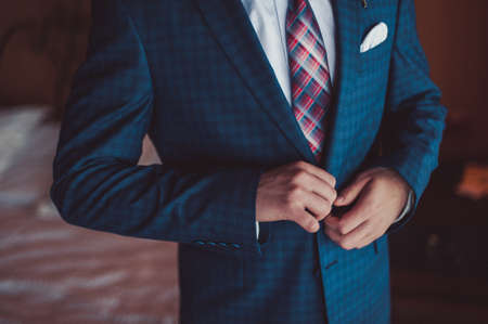 A man dresses a jacket of black, blue, gray and colorの写真素材