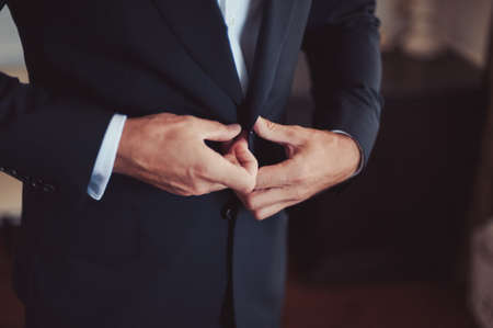 A man dresses a jacket of black, blue, gray and colorの写真素材