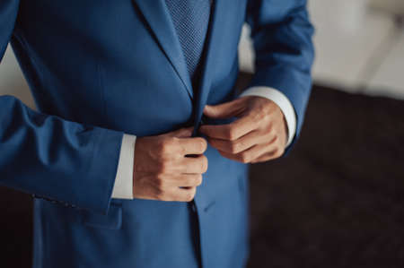 A man dresses a jacket of black, blue, gray and colorの写真素材