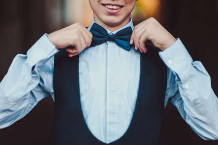 The groom puts on a butterfly. A business man dresses a butterfly.の写真素材