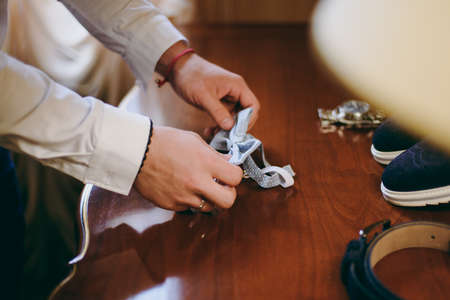 The groom puts on a butterfly. A business man dresses a butterfly.の写真素材