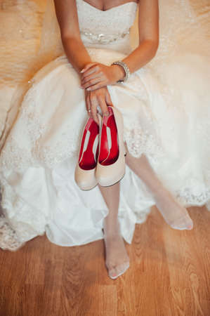 Bride Putting On Wedding Shoesの写真素材