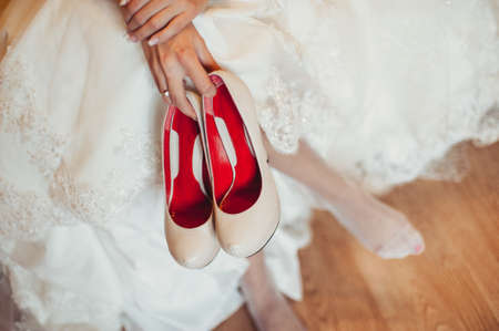 Bride Putting On Wedding Shoesの写真素材
