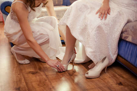 Bride Putting On Wedding Shoesの写真素材