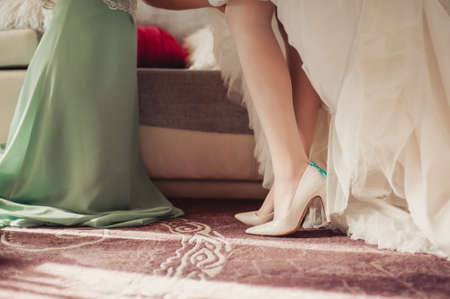 Bride Putting On Wedding Shoesの写真素材