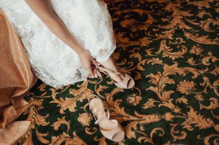 Bride Putting On Wedding Shoesの写真素材