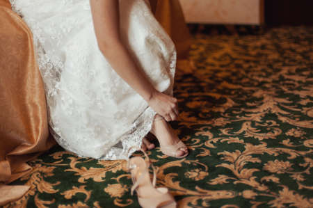 Bride Putting On Wedding Shoesの写真素材