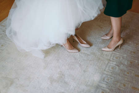 Bride Putting On Wedding Shoesの写真素材